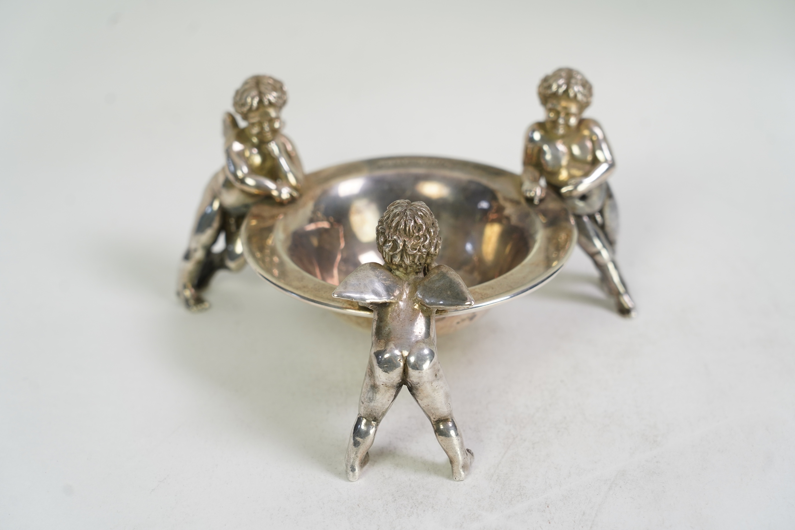 An Elizabeth II Theo Fennell silver bonbon bowl, with three cherub supports